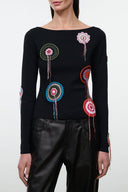 Black long-sleeve top with floral embroidery and dangling thread details