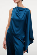 Silk sleeveless top in deep blue with draped high neckline and cape-like shoulder detail