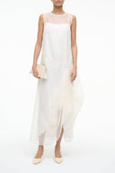 Ivory sleeveless midi dress with draped overlay and asymmetrical hem