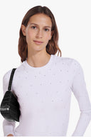 Black croc-embossed shoulder hobo bag on a model’s left side