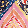 Patchwork maxi dress close-up with pink-orange diamond and blue abstract panels