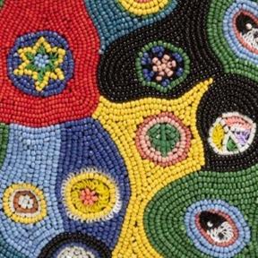 Beaded black mini bag with multicolor circular millefiori pattern.